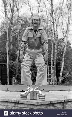 elton-john-singer-pictured-at-home-in-virginia-water-in-1973-he-is-playing-for-the-camera-over-3-pictures-pulling-faces-and-showing-off-his-hairy-legs-and-latest-platform-boots-which-are-a-5-platform-size-and-8-inches-high-they-are-silver-a.jpg