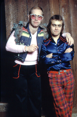 Elton John & Bernie Taupin, Los Angeles - An early portrait of Elton John with his long-time collaborator Bernie Taupin, taken when they made their first visit to Ed Caraeff’s Coldwater Canyon living room/photography studio.
