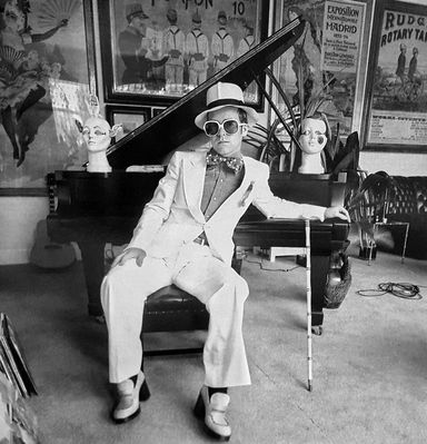 English pop singer Elton John at his home in Windsor, England, 1974. This photograph is from the album cover shoot for Elton John’s Greatest Hits album.
