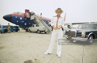 PHOTOGRAPHED BY TERRY O'NEILL
English singer Elton John on an airport runway in California during his 1974 US tour.
