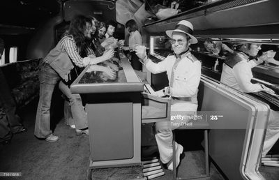 PHOTOGRAPHED BY TERRY O'NEILL
“It was just easier for rock-stars, especially at the level of Elton John, to charter private planes to get the band from one city to the next. In the 1970s, there was one specific plane that was customized to handle musicians. The Starship, as it was called, was used not only by Elton John – but also Led Zeppelin. If planes could talk!” -Terry O’Neill
