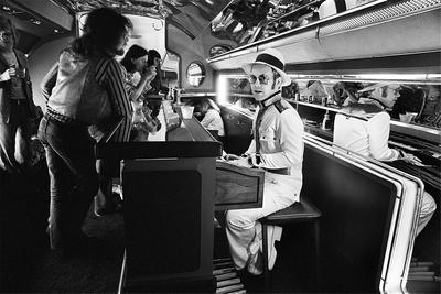 PHOTOGRAPHED BY TERRY O'NEILL
“It was just easier for rock-stars, especially at the level of Elton John, to charter private planes to get the band from one city to the next. In the 1970s, there was one specific plane that was customized to handle musicians. The Starship, as it was called, was used not only by Elton John – but also Led Zeppelin. If planes could talk!” -Terry O’Neill
