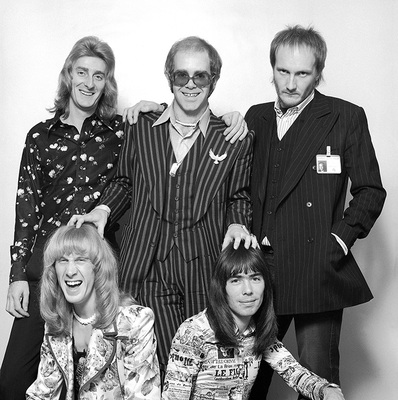 British pop singer, songwriter and musician Elton John and his band photographed in promotion of ‘Philadelphia Freedom’, London 1975.
