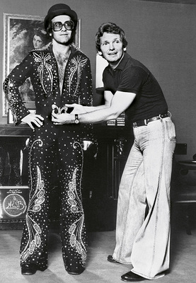 British pop singer and songwriter Elton John with famed designer Bob Mackie in Hollywood, 1974.
