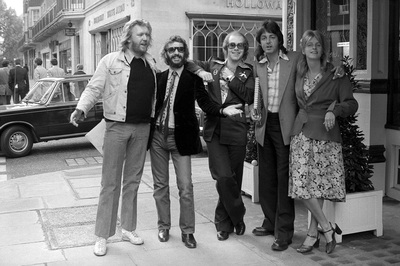 Musicians Harry Nilsson, Ringo Starr, Elton and Paul & Linda McCartney outside a restaurant in Mayfair, London, 1975.
