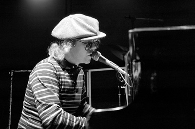 English singer,songwriter and musician Elton John warms up ahead of his performance at Dodger Stadium by playing piano where it all began, the Troubadour club, Los Angeles, 1975.
