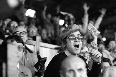 Watford FC manager Graham Taylor and pop singer Elton John cheer and spectate during a football match, late 1980s.
