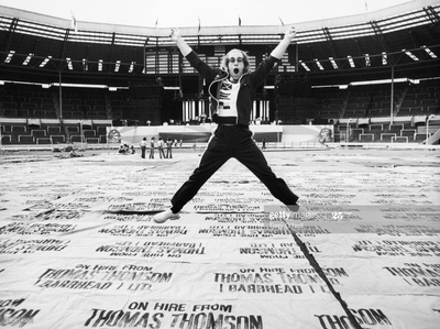 PHOTOGRAPHED BY TERRY O'NEILL
British singer Elton John leaps in the air during a rehearsal at Wembley Stadium, London, June 1975.
