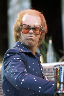 PHOTOGRAPHED BY TERRY O'NEILL
English pop singer Elton John performing on stage at Wembley Stadium, London, June 1975.
