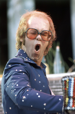 PHOTOGRAPHED BY TERRY O'NEILL
English pop singer Elton John performing on stage at Wembley Stadium, London, June 1975.
