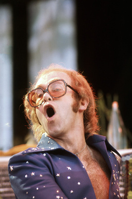 PHOTOGRAPHED BY TERRY O'NEILL
English pop singer Elton John performing on stage at Wembley Stadium, London, June 1975.
