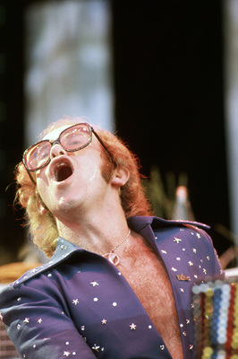 PHOTOGRAPHED BY TERRY O'NEILL
English pop singer Elton John performing on stage at Wembley Stadium, London, June 1975.
