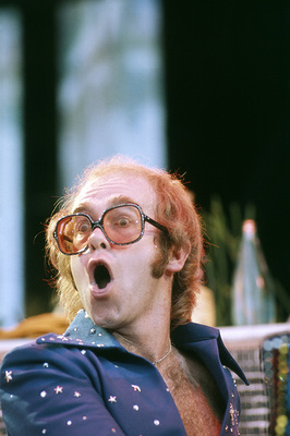 PHOTOGRAPHED BY TERRY O'NEILL
English pop singer Elton John performing on stage at Wembley Stadium, London, June 1975.
