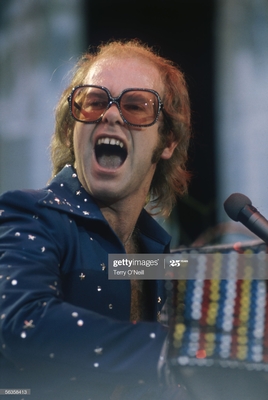 PHOTOGRAPHED BY TERRY O'NEILL
English pop singer Elton John performing on stage at Wembley Stadium, London, June 1975.
