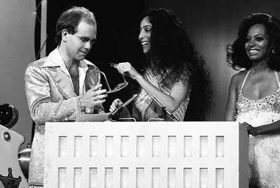 PHOTOGRAPHED BY TERRY O'NEILL
British pop singer Elton John and American singers Cher & Diana Ross at the Grammy awards, late 1970s.
