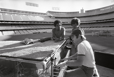 PHOTOGRAPHED BY TERRY O'NEILL
English singer songwriter Elton John rehearses at Dodger Stadium in Los Angeles, 1975.
