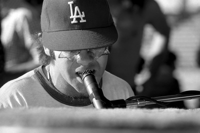 PHOTOGRAPHED BY TERRY O'NEILL
English singer songwriter Elton John rehearses at Dodger Stadium in Los Angeles, 1975.
