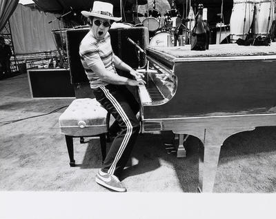 PHOTOGRAPHED BY TERRY O'NEILL
English singer songwriter Elton John rehearses at Dodger Stadium in Los Angeles, 1975.
