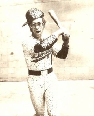 PHOTOGRAPHED BY TERRY O'NEILL
English singer and songwriter Elton John poses in Bob Mackie’s now famous sequined white Dodgers uniform at Dodger Stadium in Los Angeles, October 1975.
