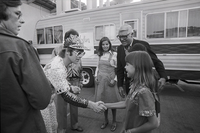 PHOTOGRAPHED BY TERRY O'NEILL
British pop singer and songwriter Elton John and actor Cary Grant meet and greet fans backstage at Dodger Stadium, Los Angeles, 1975.
