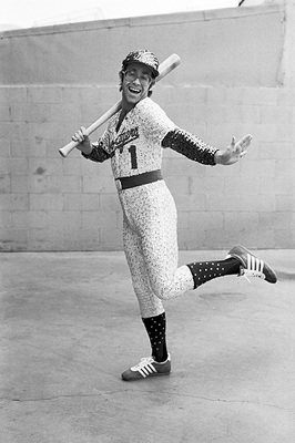 PHOTOGRAPHED BY TERRY O'NEILL
English singer and songwriter Elton John poses in Bob Mackie’s now famous sequined white Dodgers uniform at Dodger Stadium in Los Angeles, October 1975.
