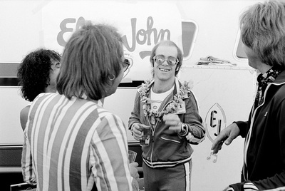 PHOTOGRAPHED BY TERRY O'NEILL
British pop singer and songwriter Elton John and members of his band backstage at Dodger Stadium, Los Angeles, 1975.
