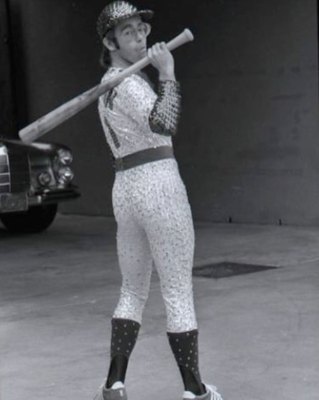 PHOTOGRAPHED BY TERRY O'NEILL
English singer and songwriter Elton John poses in Bob Mackie’s now famous sequined white Dodgers uniform at Dodger Stadium in Los Angeles, October 1975.
