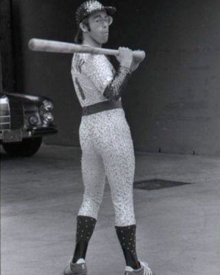 PHOTOGRAPHED BY TERRY O'NEILL
English singer and songwriter Elton John poses in Bob Mackie’s now famous sequined white Dodgers uniform at Dodger Stadium in Los Angeles, October 1975.
