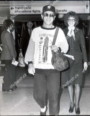 sir-elton-john-singer-and-musician-1978-chairman-of-watford-football-club-elton-john-flew-back-into-london-today-wearing-a-baseball-cap-and-t-shirt-that-matched-his-light-hearted-mood-shutterstock-editorial-892642a.jpg