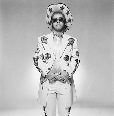 English pop star and pianist Elton John wearing a floral applique suit and sunglasses during a photoshoot in promotion of his album ‘Honkey Chateau’, 1972.
