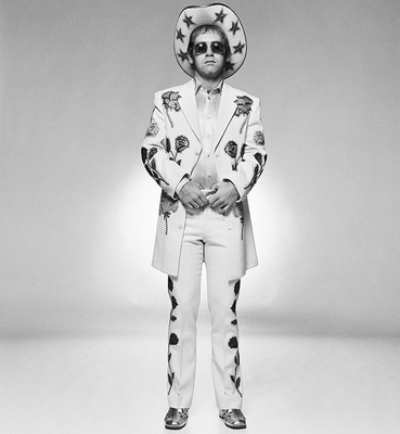 English pop star and pianist Elton John wearing a floral applique suit and sunglasses during a photoshoot in promotion of his album ‘Honkey Chateau’, 1972.
